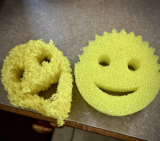 Old worn kitchen sponge next to a new replacement sponge.
