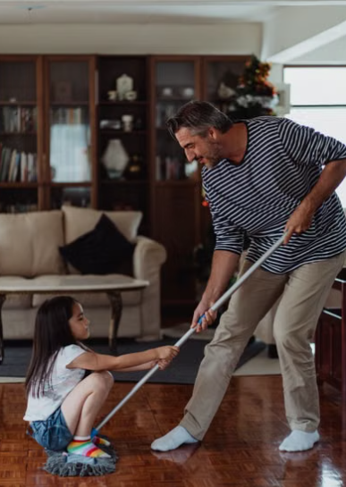 Homeowner dry-mopping a finished hardwood floor while monitoring indoor humidity. - hardwood floor cleaning
