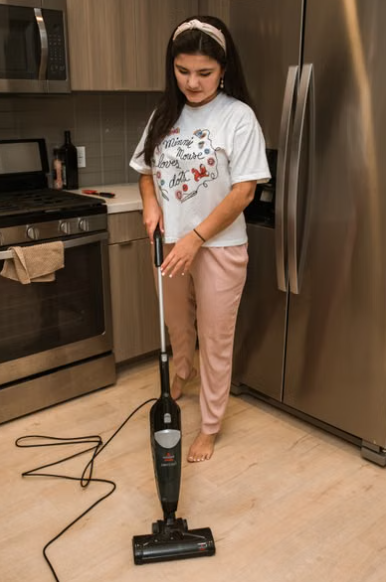 Homeowner removing grit from vinyl plank flooring before damp cleaning. -  vinyl plank floor cleaning