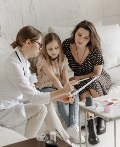 Parent and pediatrician reviewing a child’s immunization record. - new childhood vaccine order