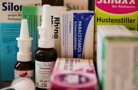 Prescription, OTC, and supplement products arranged beside a current medication list for drug interaction check